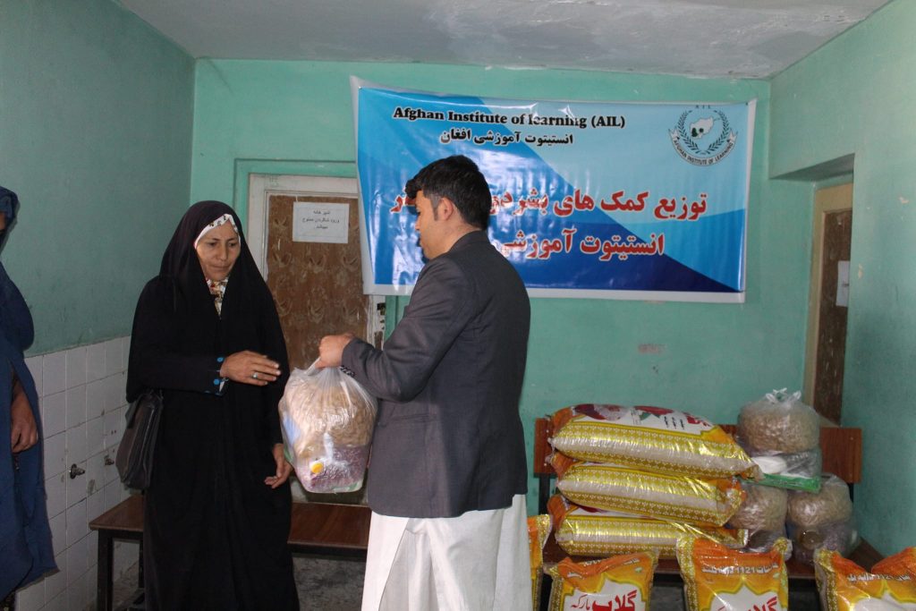 Update for Humanitarian Aid. Our People Handing Out food To A Woman 
