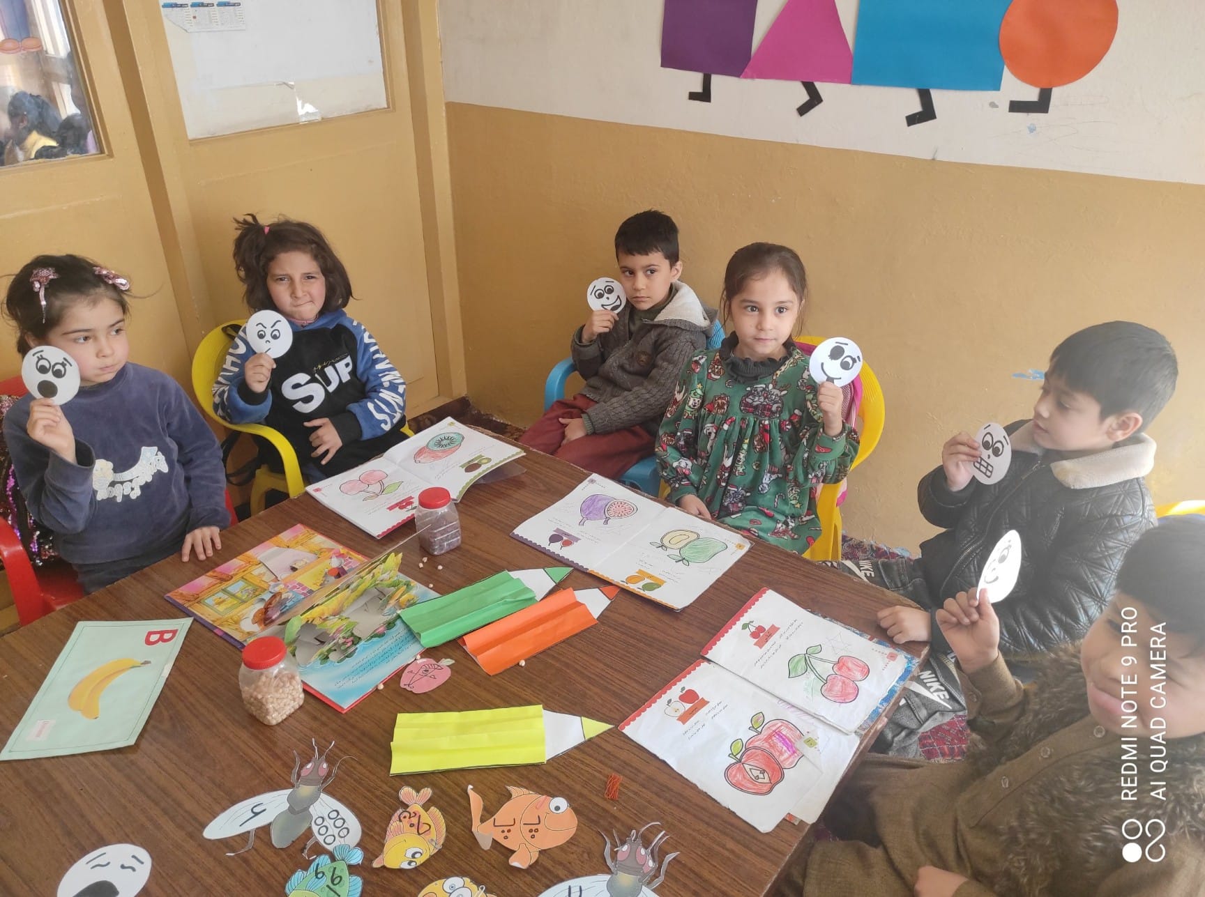 New Picture Of Children Seated At A Table Engaged In Learning Activities Such as Coloring And Writing to Update Our Family and Friends on Our Progress